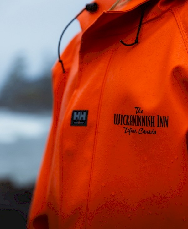 Closeup of orange Wickaninnish Inn raincoat with logo
